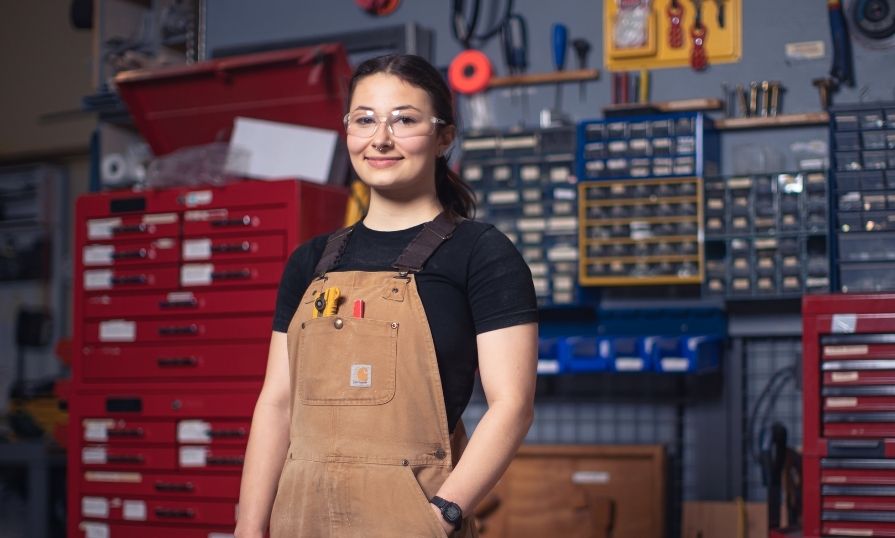 Carpentry student Hilary stands in an NSCC classroom shop.