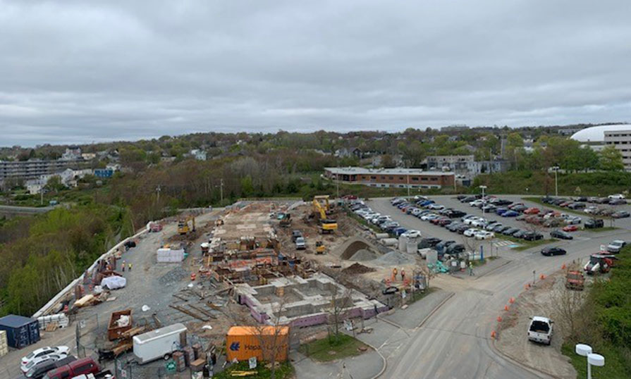 A construction site is shown, The ground is being excavated in preparation for concrete to be poured.