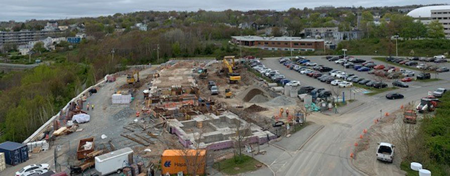 A construction site is shown, The ground is being excavated in preparation for concrete to be poured.