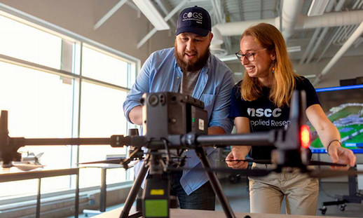 Keith Cusson, an NSCC graduate certificate program grad, works with a colleague on a large drone.