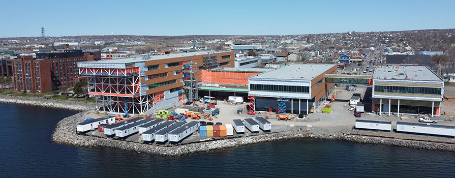 A drone looks down at the new campus building under construction on the Sydney Harbour.