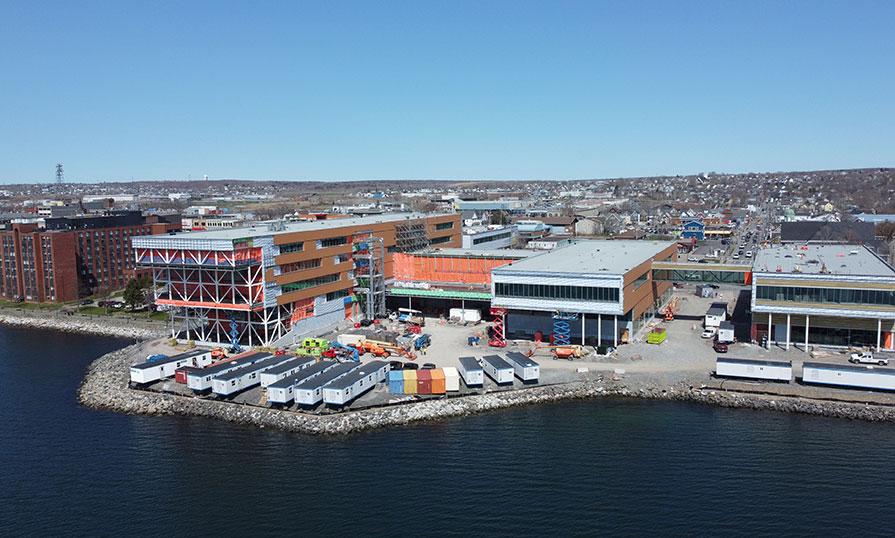 A drone looks down at the new campus building under construction on the Sydney Harbour.