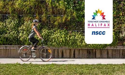 A woman is riding a bike passed a wall covered in live plants. There is a NSCC logo in the top right corner with the Together | Ensemble conference logo.