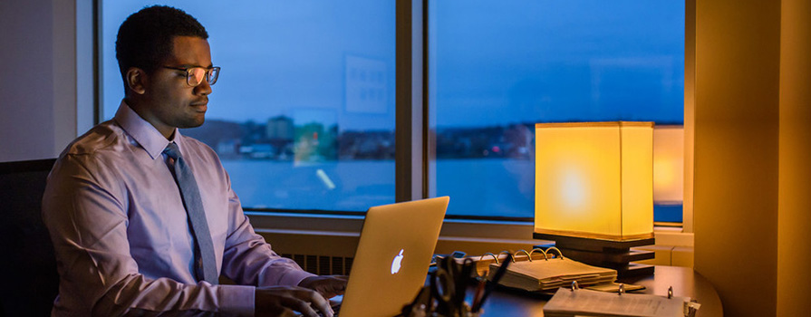 Business graduate working at his desk. 