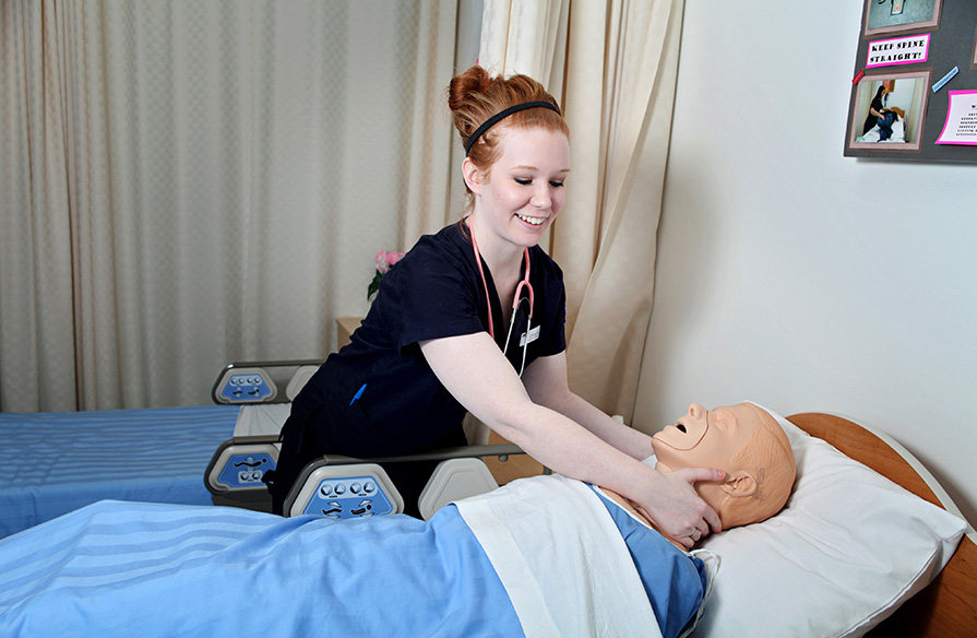 A Practical Nursing student practicing skills they have learned in class.