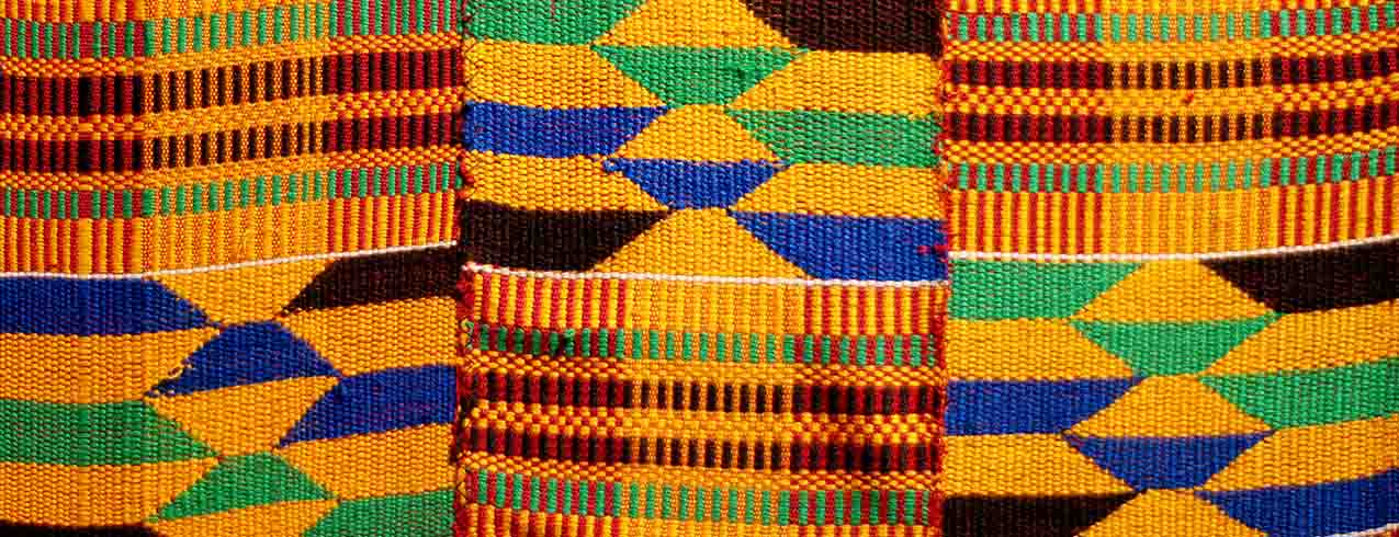 A close-up photograph highlighting the woven details of a piece of Kente cloth.