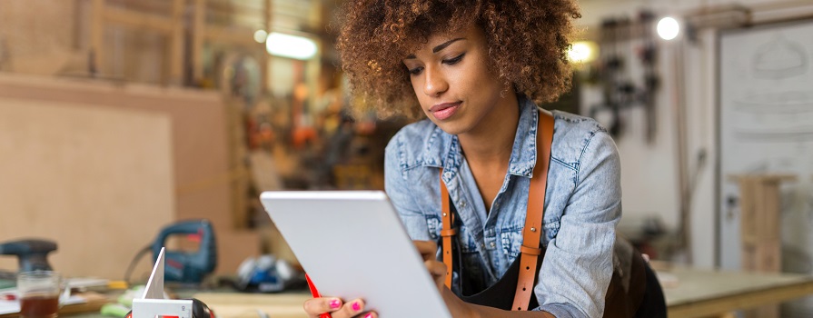 A woman looking at a tablet.