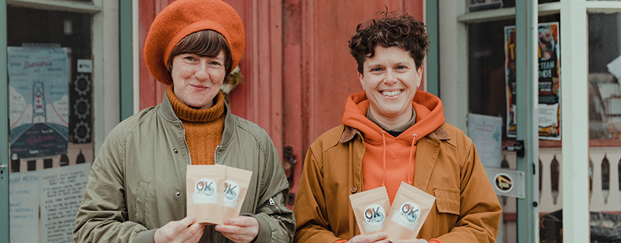 Kim, Business Administration student, and her partner Onya are holding a few packages of their sea salt outside a local store in LaHave, Nova Scotia.