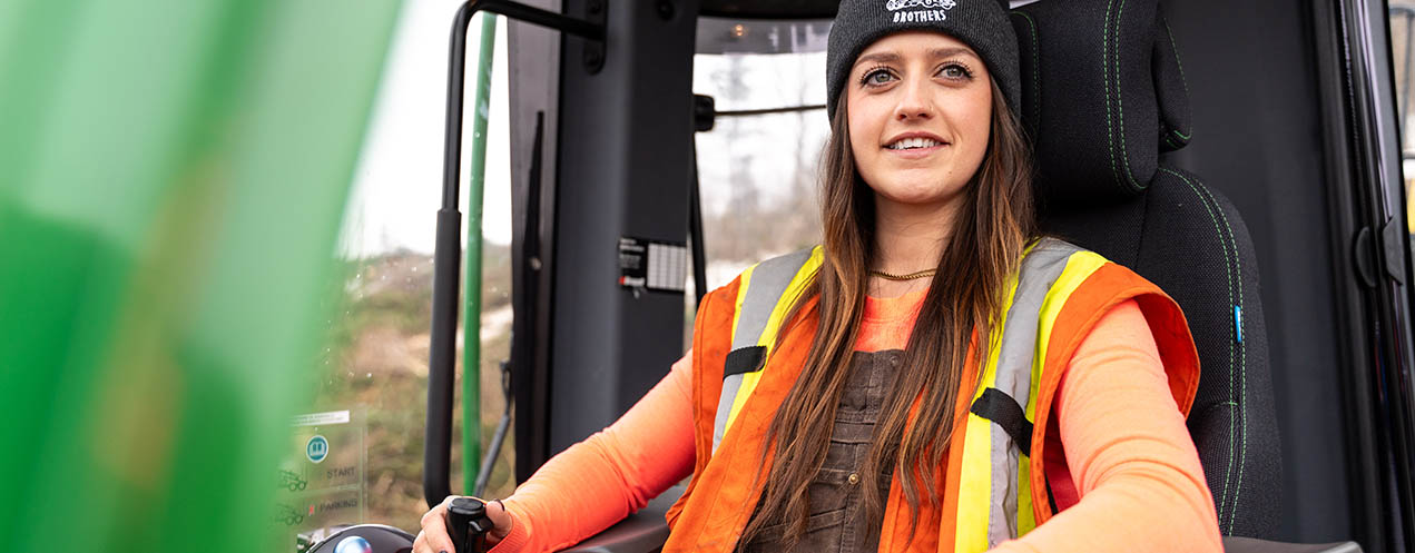 A female machine operator using a forest machine.