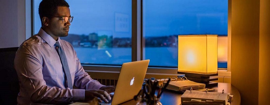 NSCC business grad Emmanuel Simmonds works at his computer.