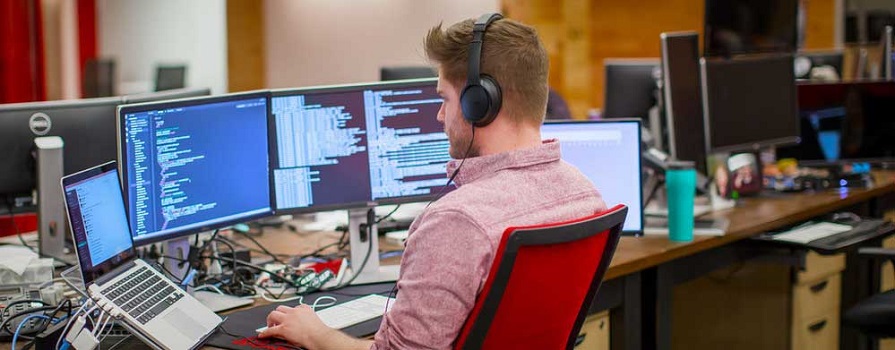 An NSCC grad works on his computer at REDspace.