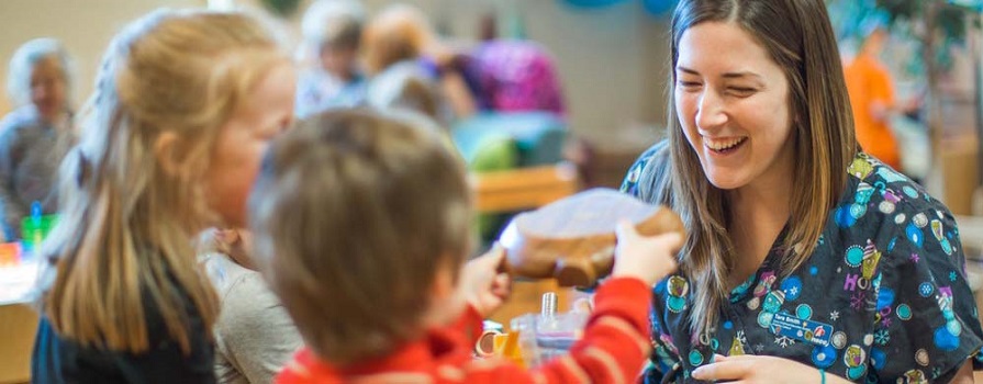 An Early Childhood Education student works with kids at Kingstec Campus.