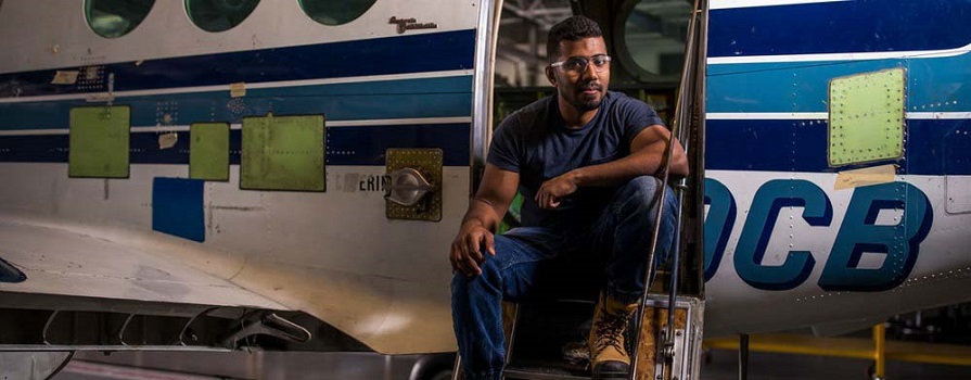 Mithun Mathew inspects the underside of an airplane.