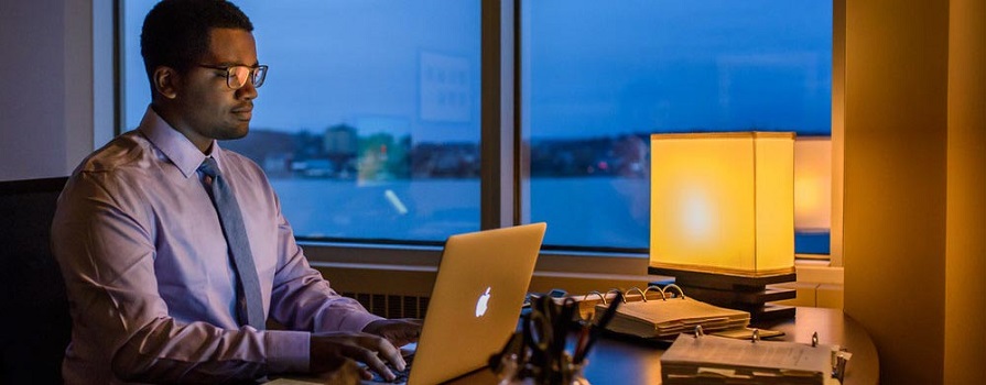 NSCC business grad Emmanuel Simmonds works at his computer.