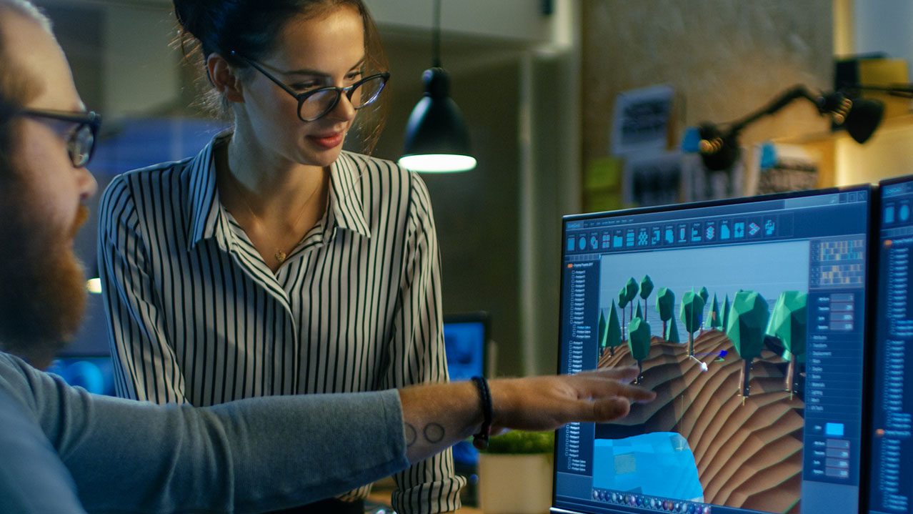 A woman in a striped shirt looks at a computer screen.