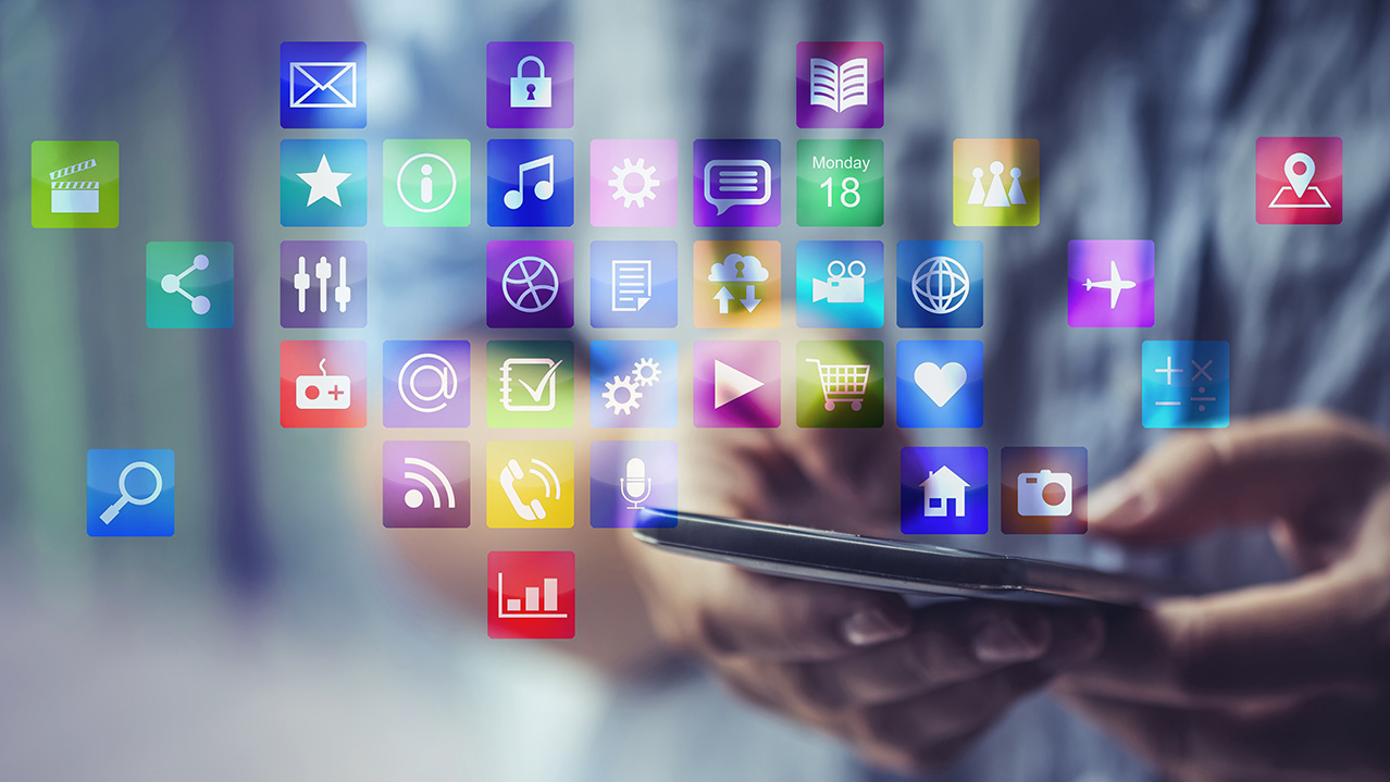 A close up photo of hands using a smartphone to access a variety of applications.