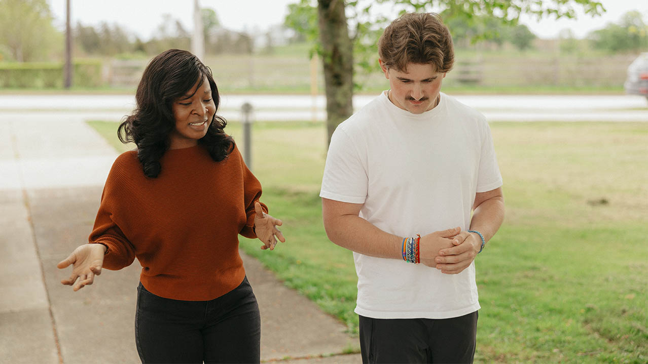 Two NSCC Social Services student discuss what they're learning in class while walking outside together.