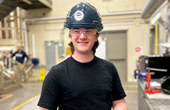 Pipe Trades student Austin stands in the shop at IT Campus.