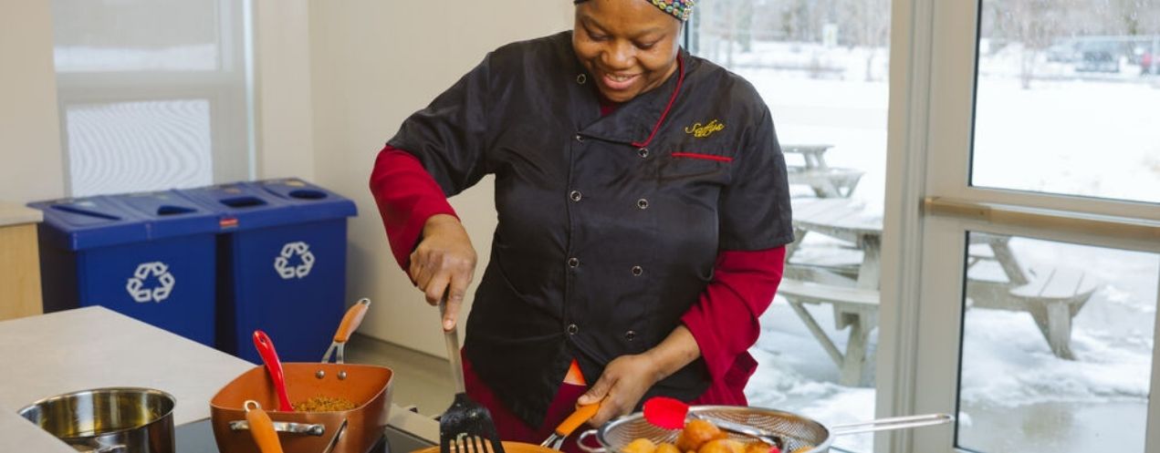 Sekinah Alagbe wears a chefs coat as she makes sweet treats for her business.