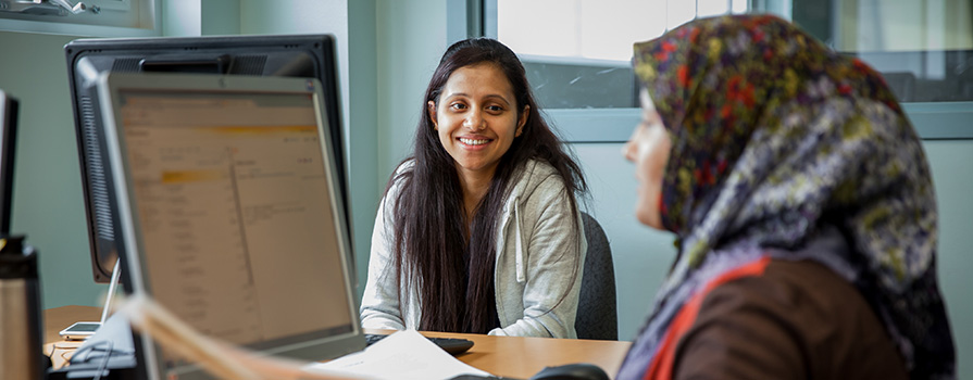 A female student working with an EAL supporter.