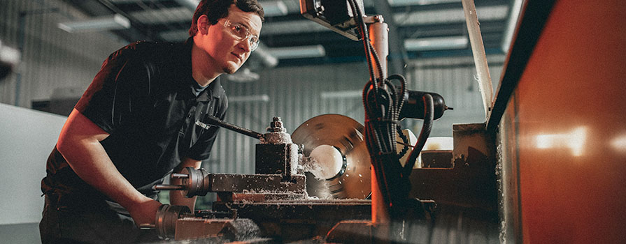 A male student welding in class.