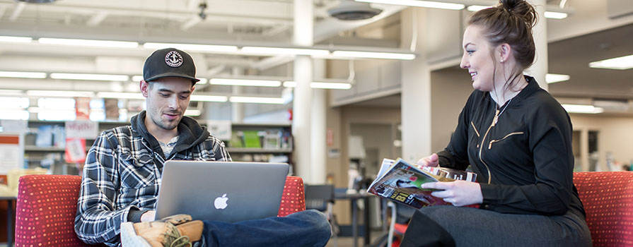 A male and female student working together.
