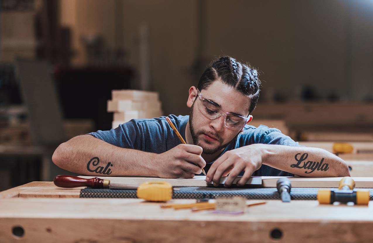 A man works on his cabinetmaking project.