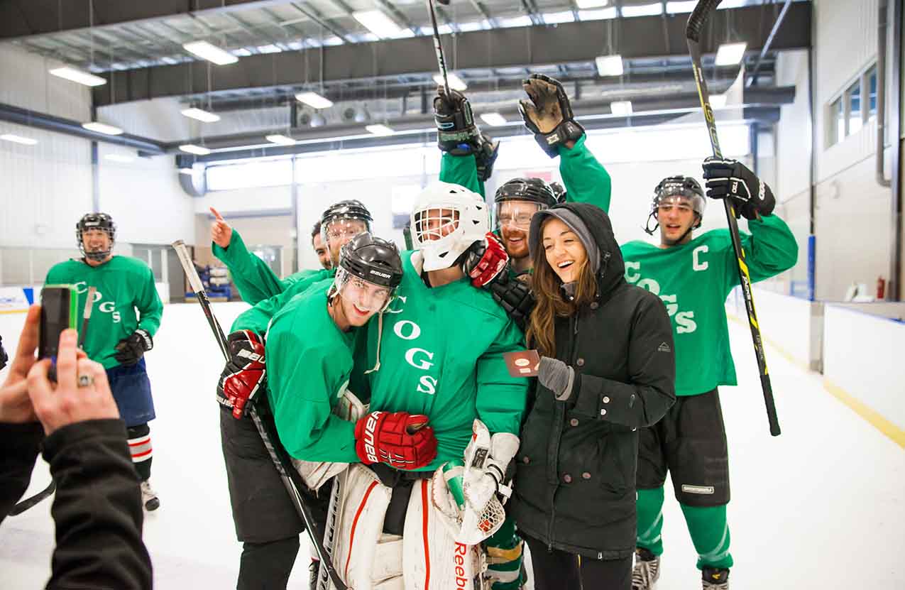 A group of COGS students during an ice hockey match celebrating their win. 