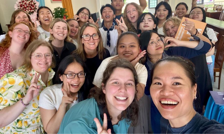 A group of smiling NSCC students pose together for a joyful selfie.