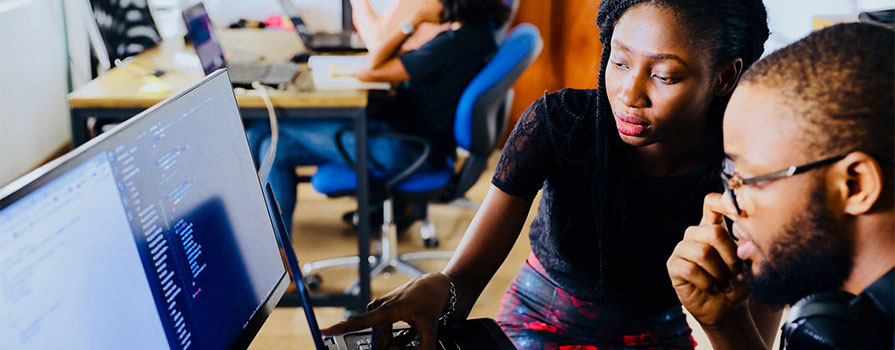 Two people working at a computer
