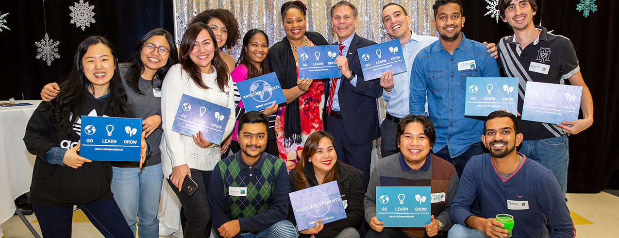 NSCC International students pose with NSCC President Don Bureaux during  the annual Holiday Party at NSCC Akerley Campus