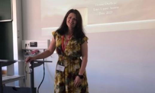 Denise posing in a classroom