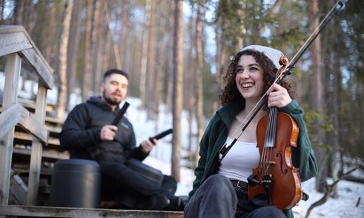 Ella playing an instrument and smiling