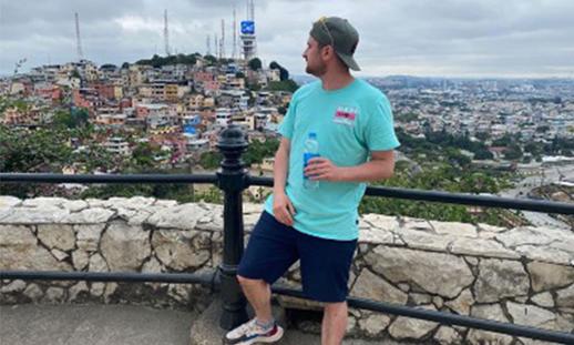 Mitchell posing with an urban landscape in the background