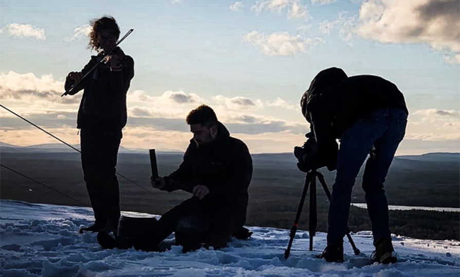 Nick and two other people playing instruments outdoors