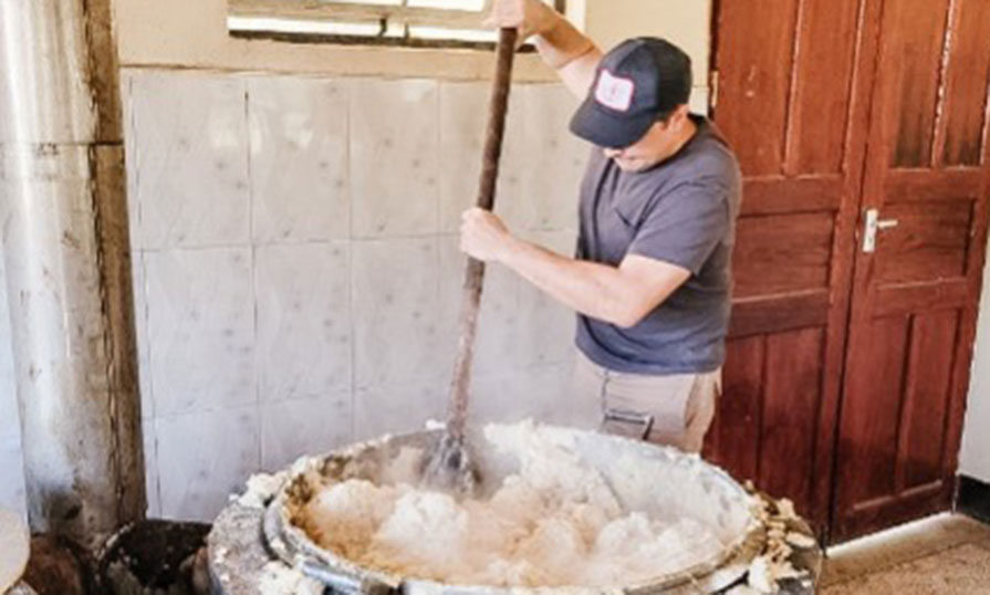 Stephen stirring content in a large pot