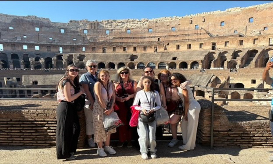 Wendi Dewey and International Tourism group at the Colosseum in Rome